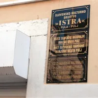 Tabla ob vhodu v prostore galerije SKD Istra v Pulju