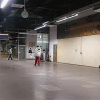 Tu so še pred kratkim stali prodajni pulti. V ozadju nedelujoč video ekran.