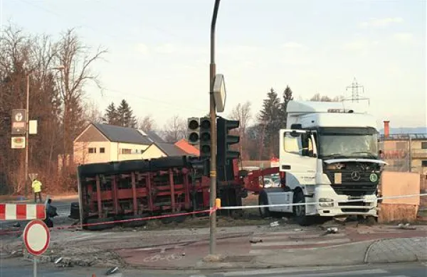 Po trčenju se je priklopnik tovornjaka prevrnil na bok ...