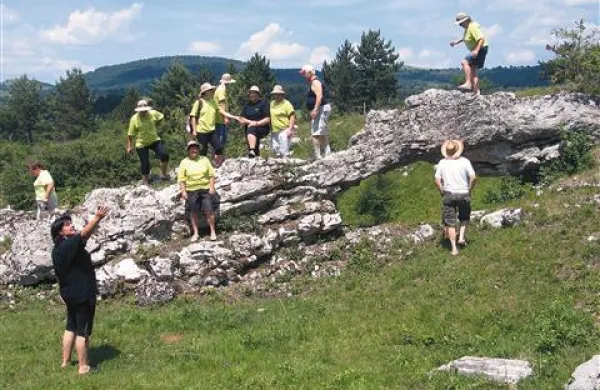 Udeleženci pohoda na eni od zanimivih točk, na naravnem kamnitem mostu nad Bačem