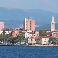 Rdeča stolpnica štrli iz mestne vedute, kar je posledica povojne arhitekture pod taktirko Eda Mihevca

