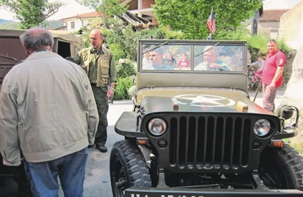   Vojaške starodobnike so si pred Dujčevo domačijo z zanimanjem ogledali tudi prebivalci Škofelj 