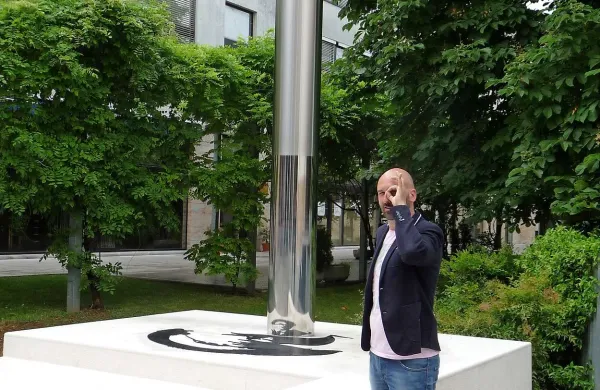 Simon Kastelic ob spomeniku Srečku Kosovelu s “Černigojevim” očesom