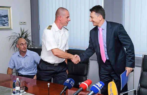 Primož Bajec z uprave za pomorstvo je Dragu Matiću (desno) prinesel odločbo, da v pristanišče dovolijo kontejnerskim ladjam z ugrezom 13,5 metra 