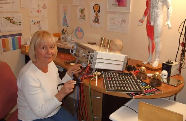 Diana Morgan z napravo za bioresonanco in nizom pripomočkov za analizo bolezenskih tegob 