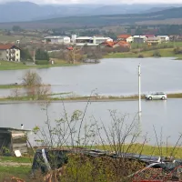 Med Knežakom in Bačem (v ozadju) je že nekaj dni zraslo veliko jezero, ki je zalilo tudi cesto med obema vasema