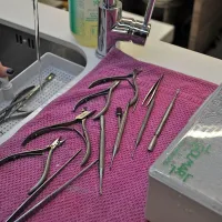 Pripomočke operejo pod tekočo vodo, sledi polurna dezinfekcija v za to namenjeni dezinfekcijski tekočini v tako 
imenovanem mokrem sterilizatorju.