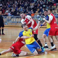 Grega Krečič (z žogo) je pripravljen na čvrste prijeme rokometašev 
Loke.