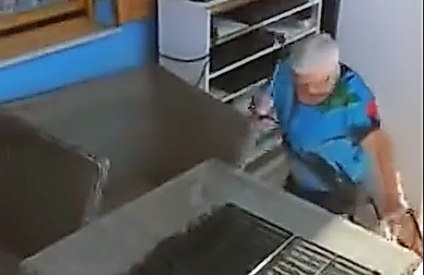 Na posnetku je videti starejšo žensko, ki psa drži za zadnjo taco in 
ga pretepa s predmetom, podobnim palici.