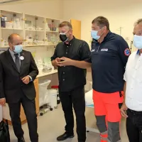 Minister Janez Poklukar (drugi z leve) je danes znova pozval k 
cepljenju. V Bovcu je precepljenost  še vedno nizka.
