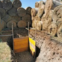 Priprava jame, v katero bodo pred začetkom onesposobitve 
spustili bombo in bariere iz bal sena.