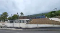 Napokani  stebri iz lepljenega lesa podpirajo del strehe, ki naj bi jo 
zatravili.   