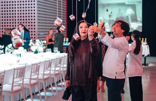 Marina Abramović in Tomaž Kavčič med lebdečimi kozarčki z 
ajvarjem in kremo iz slovenskega mladega sira, vrh kozarčka pa je 
pokrival kaviar iz ajvarja.