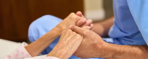 A healthcare worker holds an elderly patient's hands, providing comfort and care at a senior rehabilitation center. An image symbolizing support, compassion, and professional healthcare for senior members.,Image: 962765063, License: Royalty-free, Restrictions:, Model Release: yes, Credit line: Robert Kneschke/Alamy/Profimedia