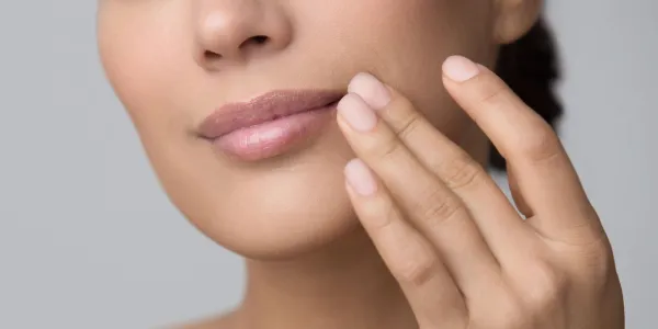 Lips Care. Woman Applying Balsam Over Grey Studio Background, Crop,Image: 1017046590, License: Royalty-free, Restrictions:, Model Release: no, Credit line: Prostock-studio/Alamy/Profimedia