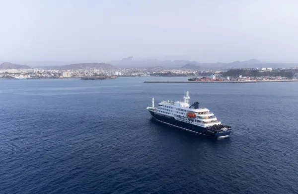 This aerial picture shows a general view of the cruise ship MV Hondius stationary off the port of Praia, the capital of Cape Verde, on May 5, 2026. The WHO said on May 5, 2026 that Spain would "welcome" a cruise ship anchored off Cape Verde with suspected hantavirus cases onboard, enabling a probe and assessment of the risk to the remaining passengers. WHO epidemic and pandemic preparedness and prevention director Maria Van Kerkhove told reporters the ship would head for the Canary islands.,Image: 1096675323, License: Rights-managed, Restrictions:, Model Release: no, Credit line: AFP/AFP/Profimedia