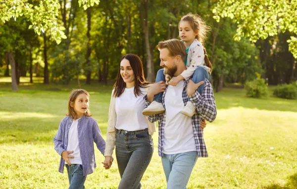 Happy smiling family of four with two kids boy and girl walking in summer park enjoying beautiful nature. Young parents and their children enjoying spending time together outdoors.,Image: 1008256646, License: Royalty-free, Restrictions:, Model Release: no, Credit line: Roman Lacheev/Alamy/Profimedia