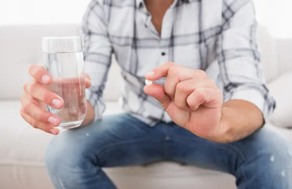 Man with his medicine laid out on coffee table,Image: 217804509, License: Royalty-free, Restrictions:, Model Release: yes, Credit line: -/Wavebreak/Profimedia