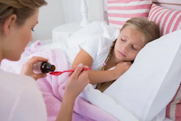Mother about to give medicine to sick daughter at home in the bedroom,Image: 231369596, License: Royalty-free, Restrictions:, Model Release: yes, Credit line: -/Wavebreak/Profimedia