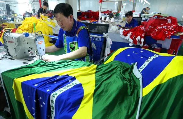 A worker makes Brazilian flags ahead of the World Cup football tournament, at a factory in Qingdao, in China's Shandong province on May 28, 2026. The factory is producing official flags of the 48 countries represented at the World Cup football tournament.,Image: 1106435854, License: Rights-managed, Restrictions: China OUT, Model Release: no, Credit line: AFP/AFP/Profimedia