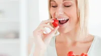 Woman enjoying eating strawberries in the kitchen,Image: 138523598, License: Royalty-free, Restrictions:, Model Release: yes, Credit line: -/Wavebreak/Profimedia