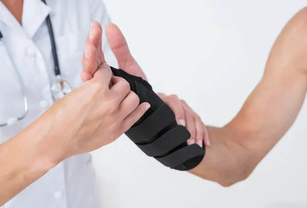 Doctor examining a man wrist in medical office,Image: 253441507, License: Royalty-free, Restrictions:, Model Release: yes, Credit line: -/Wavebreak/Profimedia