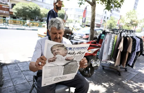 A man reads a copy of the Iranian daily newspaper Hamshahri bearing an image of the US president and a headline that reads "Gone with the wind" at a kiosk in Tehran on June 18, 2026. The United States and Iran have signed a deal to end the Middle East war, with a ceremony set for June 19 in Switzerland that will mark the start of a 60-day negotiation period. The memorandum of understanding aims to put an end to months of conflict initiated by US-Israeli strikes on Iran in February, which wreaked chaos across the region and rattled the global economy.,Image: 1110987309, License: Rights-managed, Restrictions: Israel OUT/NO Access Israel Media/Persian Language TV Stations Outside Iran/Strictly No Access BBC Persian/VOA Persian/Manoto TV/Iran International/ Radio Farda --Attention editors: AFP covers the war in the Middle East through its extensive regional network, including bureaus in Tehran, Jerusalem, and several neighboring countries. Since the start of the conflict, journalists have been working under increasingly restrictive conditions. Authorities in several countries have limited reporters' movements, photo and live video coverage from sensitive locations. Some governments and armed groups have banned images of missile or drone strikes and other security-related sites., Model Release: no, Credit line: AFP/AFP/Profimedia