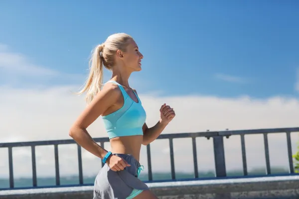 fitness, sport, people and healthy lifestyle concept - smiling young woman with heart rate watch running outdoors,Image: 258844920, License: Royalty-free, Restrictions:, Model Release: yes, Credit line: Lev Dolgachov/Alamy/Profimedia