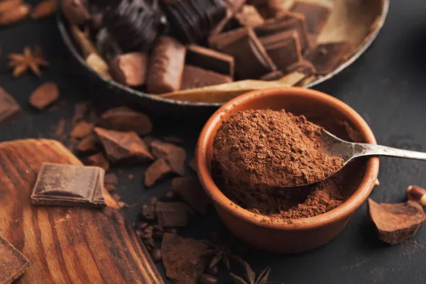Chocolate background. Bowl and vintage spoon with cocoa powder, variety of candies and spices on black slate table, closeup. Sweet wallpaper, confectionery shop advertising and cooking ingredients,Image: 1081917881, License: Royalty-free, Restrictions:, Model Release: no, Credit line: Prostock-studio/Alamy/Profimedia