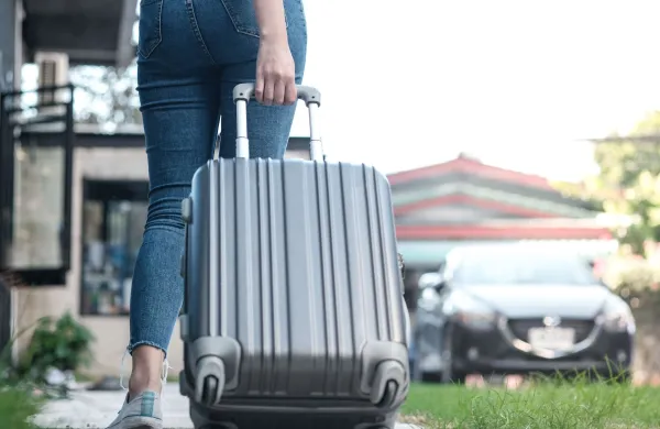 Traveler woman carrying luggage. Tourist walking with Suitcases Travel lifestyle concept